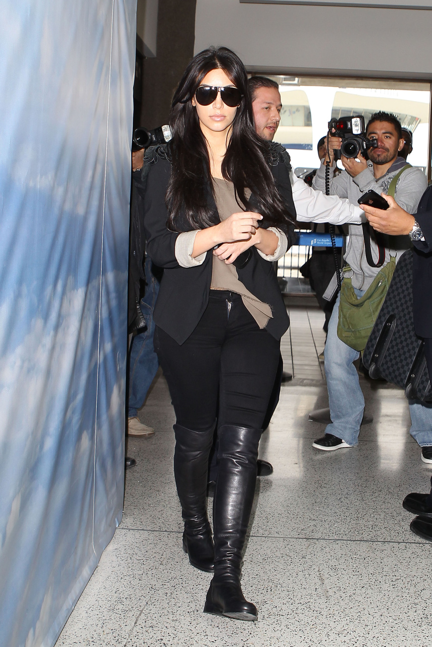 Kim Kardashian itt is térd fölé érő csizmával rövidíti lábait.