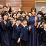 Ebben a vékony övvel átfogott sötétkék Dior ruhában látogatott meg egy tokiói általános iskolát. Az iskolaköpeny színéhez passzoló francia dizájner ruha 2657 fontba, kb.937 ezer forintba kerül a Diornál.

