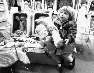 1983. december: kislány az év egyik legnépszerűbb játékával, a Cabbage Patch Kid babával. Annyira népszerű volt a játék, hogy Amerikában rendőrt kellett hívni az áruházban érte kitört verekedésekhez.

