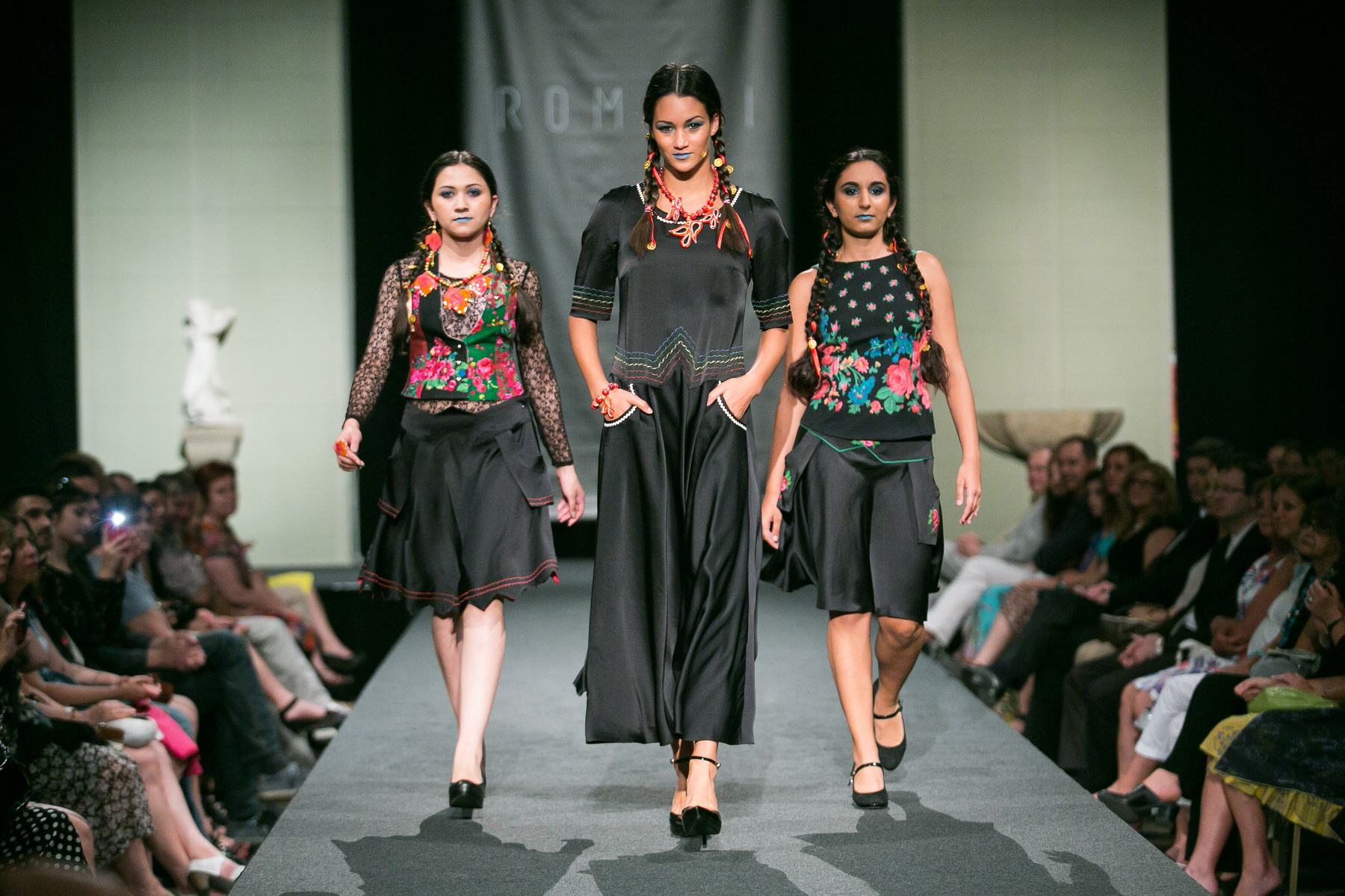 Középen a ruhákat tervező Varga Erika, mellette kétoldalt Diós Gabriella és Varga Helena, hátérben a modellek.